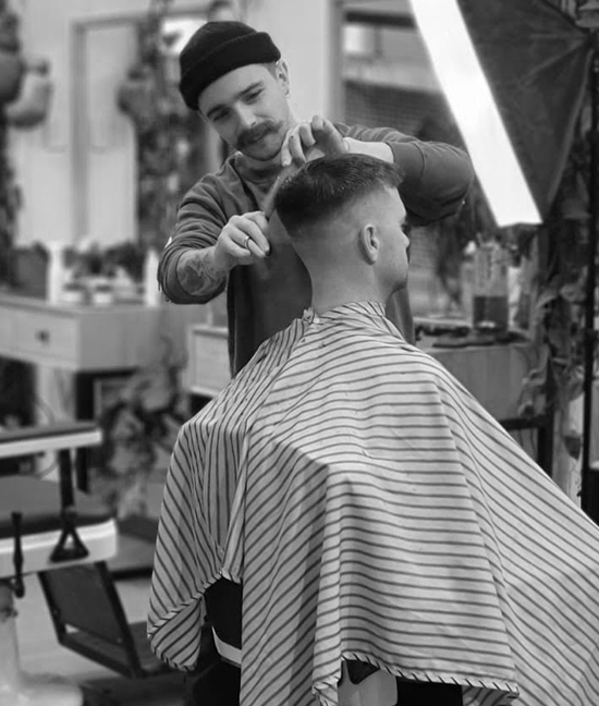 Barber cutting clients hair at Highett barbershop
